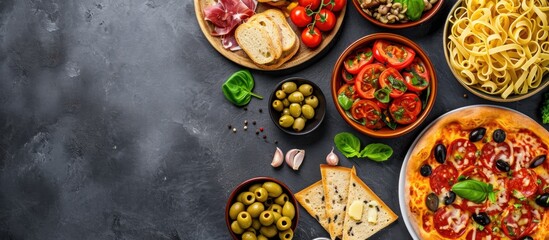 Mediterranean food: pasta, pizza, olives, and antipasto. Flat lay with room for text.