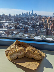 Everything bagel with the New York City skyline in the distance