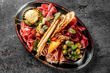 Antipasto plate with ham, prosciutto, salami, cheese, vegetables and olives
