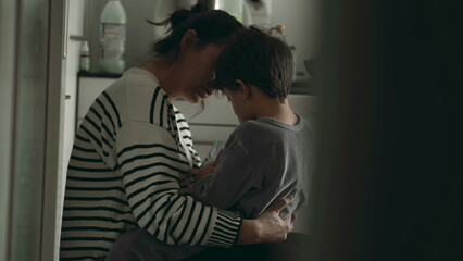 Caring Mother Comforts Upset Little Boy - Genuine Moment of Empathy. Candid and tender scene of compassionate mother consoles her crying son - obrazy, fototapety, plakaty