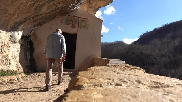 Roccamorice, Italy A man walks into the Hermitage of San Bartolomeo, an ancient abbey carved into the rock. 