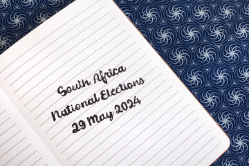South Africa National elections 29May handwritten on notebook, with traditional South African Shwe...
