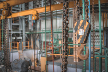 a lift with a hook in the industrial hall of an abandoned plant