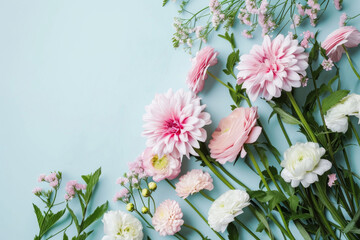 Flowers composition background on blue background with copy space, top view, gift card or poster