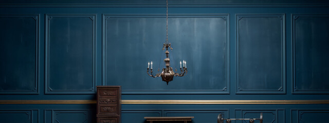 Blue paneled room with golden elements and a vintage chandelier