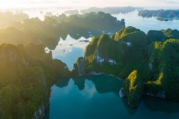 Aerial view of Ha Long Bay during sunrise and beautiful day, blue clear sky. Vietnam tourist attraction