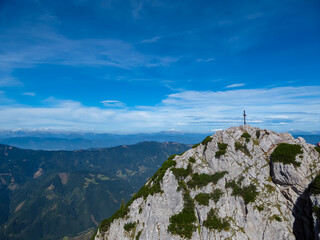 Fototapeta premium Scenic view of summit cross of majestic mountain peak Hochlantsch in Graz Highlands, Prealps East of the Mur, Styria, Austria. Wanderlust Austrian Alps. Idyllic hiking trail in alpine nature in summer