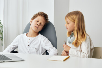 Happy Caucasian Boy and Girl Studying Online with Laptops at Home