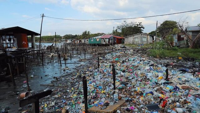 Fishing village houses over the water garbage poor areas in Sabah province in Malaysia
