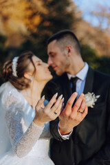 Groom and bride on the wedding day. The newlyweds show off their rings after the ceremony. Happy...