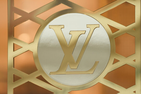 LILLE, FRANCE - FEBRUARY 21, 2024 : Golden logo sign of Louis Vuitton LV shop