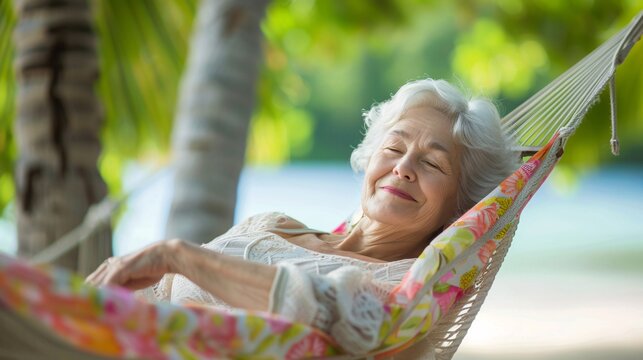 A serene senior woman smiling contentedly as she enjoys a peaceful afternoon nap in a hammock suspended between two palm trees on a tropical beach