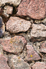 Wall of old uneven stones, background or texture