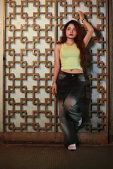 Foto op Plexiglas Young woman posing at painted decorative metal panel © DragonImages