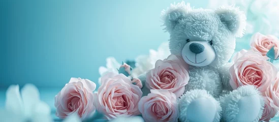 Fotobehang blue teddy bear with pink roses. with copy space image. Place for adding text or design © vxnaghiyev