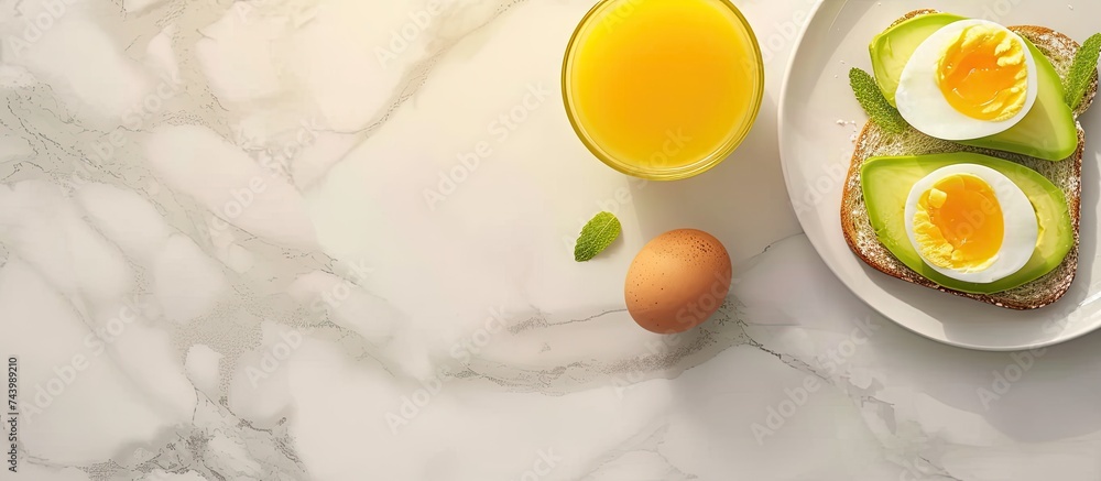 Poster breakfast with avocado toast orange juice and boiled egg top view. with copy space image. Place for adding text or design