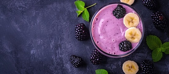 High angle view on a blackberry smoothie with banana and yogurt in a glass with straws on a gray textured table. with copy space image. Place for adding text or design - Powered by Adobe
