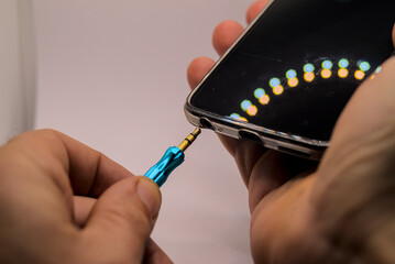 Plugging aux input cable into smartphone
