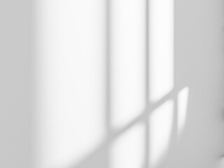 Gray window shadow and light blur abstract background on white wall.