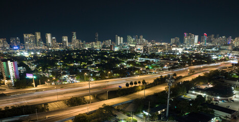 Fototapeta na wymiar Aerial view of american highway junction at night with fast driving vehicles in Miami, Florida. View from above of USA transportation infrastructure
