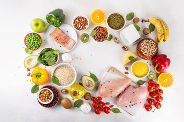 Clean Eating Diet foods background, fruits, vegetables, lean proteins, whole grains and healthy fats, nuts, legumes, chicken meat, fresh fish, beans on white background. Balanced healthy flat lay