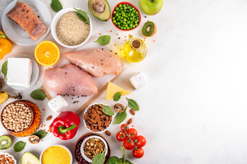 Clean Eating Diet foods background, fruits, vegetables, lean proteins, whole grains and healthy fats, nuts, legumes, chicken meat, fresh fish, beans on white background. Balanced healthy flat lay