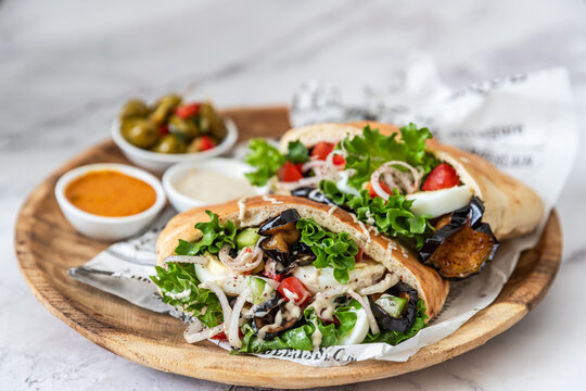 Sabich sandwich - pita stuffed with fried eggplant and hard boiled eggs and salad