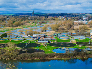 Aerial shot of Sewerage farm, flooded River Avon and Salisbury Cathedral in background