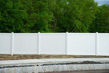 white vinyl fence fencing of private property grass plastic