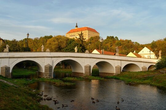 Beautiful old castle with a bridge over the river at sunset. European old architecture. Namest nad Oslavou - a city in the Czech Republic.