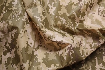 Texture of crumpled camouflage fabric as background, top view