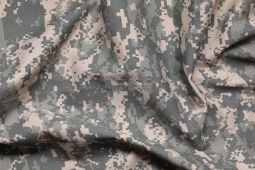 Texture of crumpled camouflage fabric as background, top view