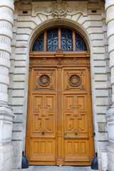 Old ornate door in Paris - typical old apartment buildiing. - 744008088