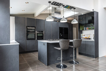 Beautiful grey slate and marble European style modern home kitchen. Elegant minimal home interior...