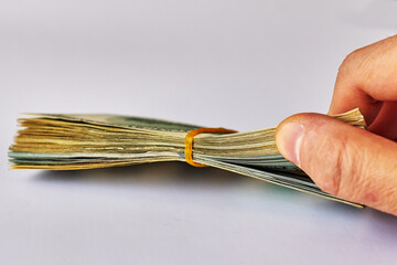 man's hand counting American dollars