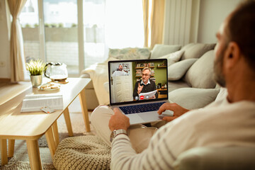 Man having video call with financial advisor from home