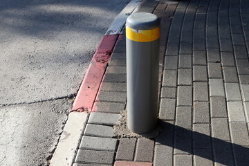Pillars along the road for the safe passage of pedestrians.