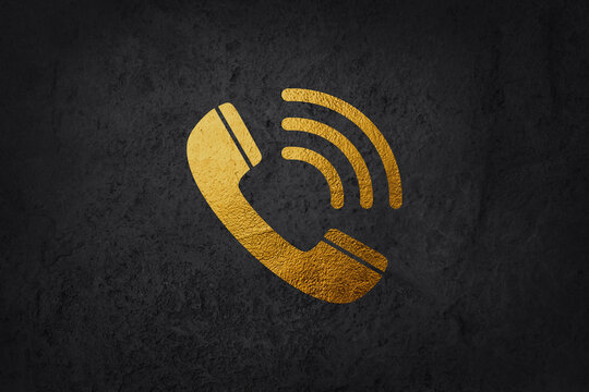 Golden phone icon in speech bubble isolated on black background.