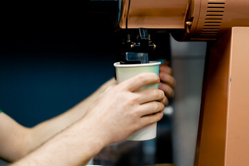 Naklejka premium coffee tester at a coffee factory with roasting freshly ground coffee into cup
