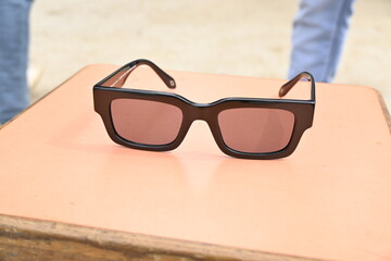 sunglasses on a table, sunglasses, sunglasses on the beach