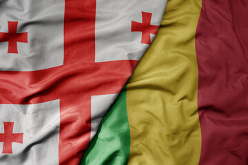 big waving national colorful flag of mali and national flag of georgia .