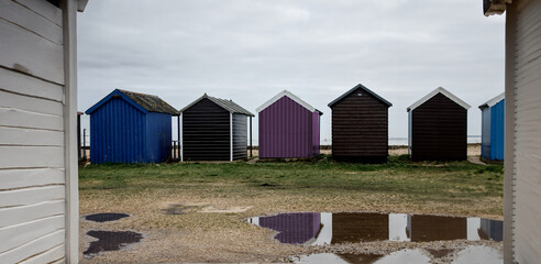 multicoloured beach huts on a wet day