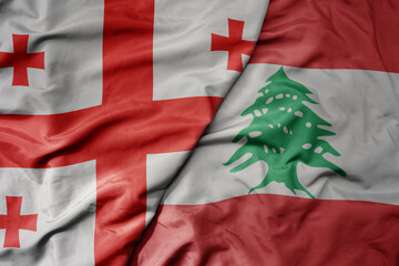 big waving national colorful flag of lebanon and national flag of georgia .
