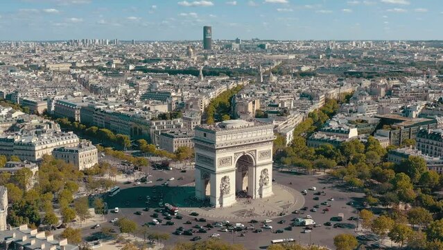 PARIS, FRANCE - MAY 30, 2023: Aerial view over Triumphal Arc traffic in central Paris cityscape. Famous touristic landmark, world heritage of architectural masterpieces.