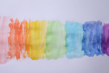 Rainbow drawing with watercolor paint on white paper, top view