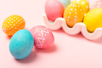 Easter eggs on a bright pink background. Easter celebration concept. Colorful easter handmade decorated Easter eggs. Place for text. Copy space.
