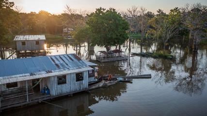 Aerial view of a flooded area (igapó) and houses on stilts, based on the traditional knowledge and...
