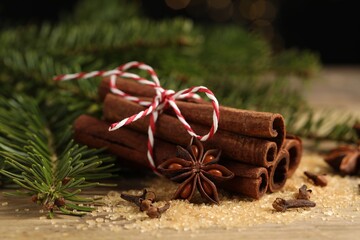 Different spices and fir branches on table, closeup