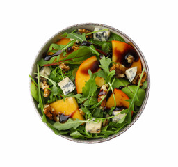 Tasty salad with persimmon, blue cheese and walnuts isolated on white