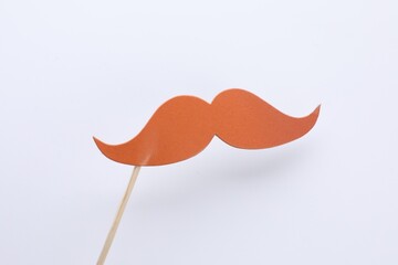 Fake paper mustache on stick against white background